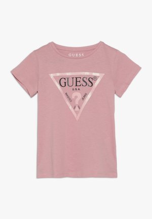 Pinkes kurzärmeliges T-Shirt mit glitzerndem Dreieck-Logo und dem Text "GUESS U.S.A. Washed Jeans" auf der Vorderseite.