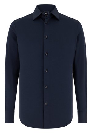 Chemise à manches longues bleu marine en tissu lisse, avec col pointu, fermeture à boutons sur le devant et poignets boutonnés.