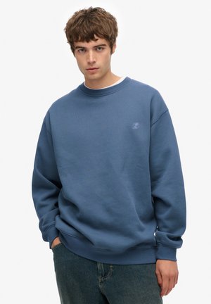 Blauwe katoenen sweatshirt met een ronde hals en geribde boorden. Bevat een klein logo op de borst. Draag het met loszittende denim jeans.