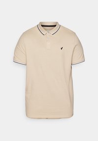 Beżowa koszulka polo z bawełny, z trzema guzikami na plastrze, czarno-białymi paskami na kołnierzyku i mankietach, oraz małym czarnym logo.