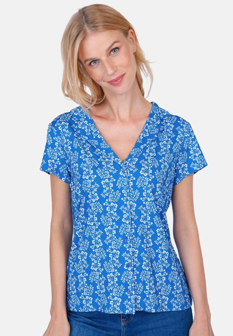 Blue floral blouse with short sleeves, V-neck, and button front. Features small white flower patterns and a soft, textured fabric.