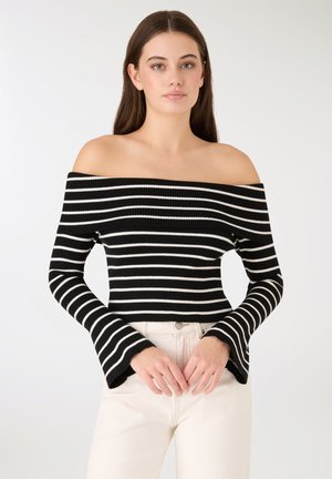 Maglione a righe bianche e nere, a spalle scoperte, con coste, maniche a campana, design aderente e texture morbida.