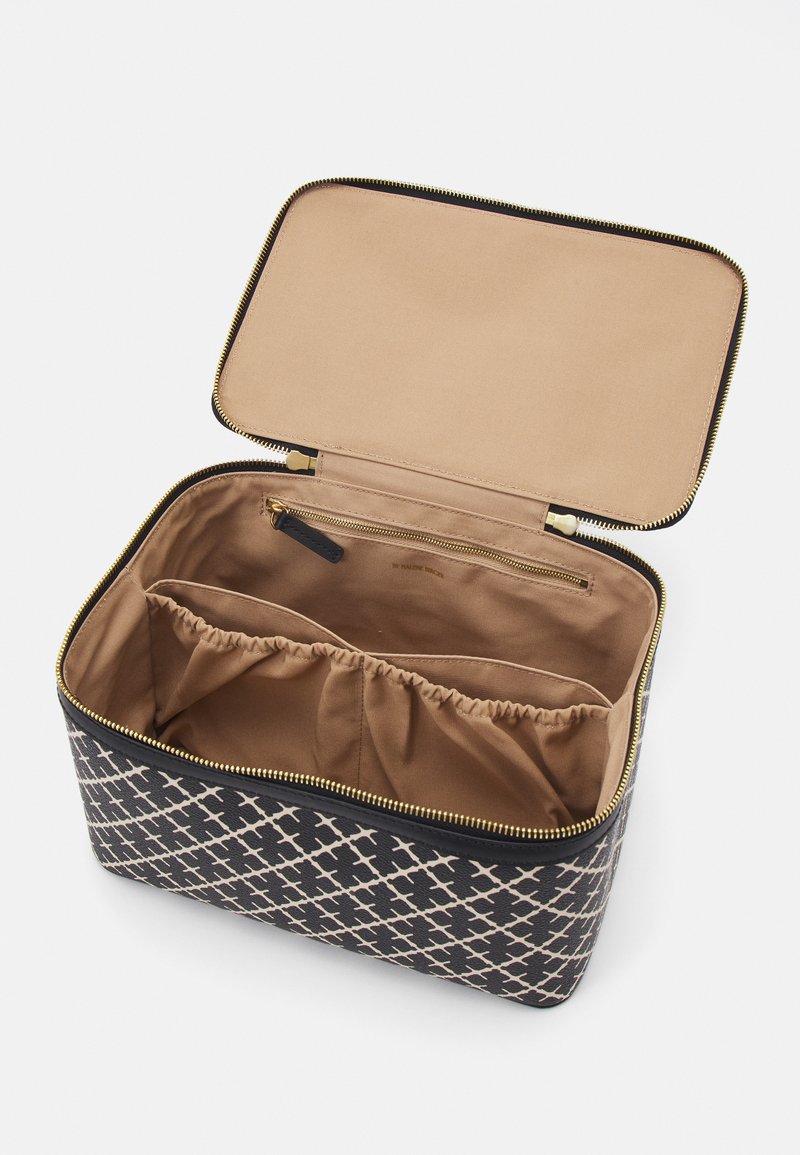 Rectangular fabric bag in navy and cream with a crisscross pattern. Tan interior with gathered sections and a zippered pocket. Gold zipper hardware.