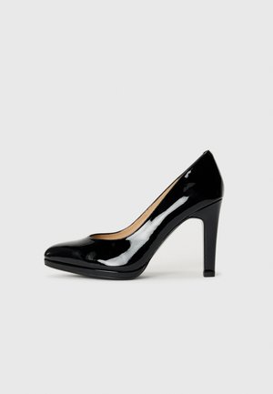 Escarpin en cuir verni noir avec un bout arrondi, un design épuré et une finition lisse et brillante. Le talon mesure environ 10 centimètres.