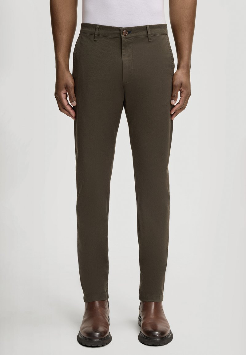 Pantaloni color verde oliva con vestibilità a gamba dritta, realizzati in tessuto leggero. Presentano un bottone frontale, passanti per cintura e tasche laterali.