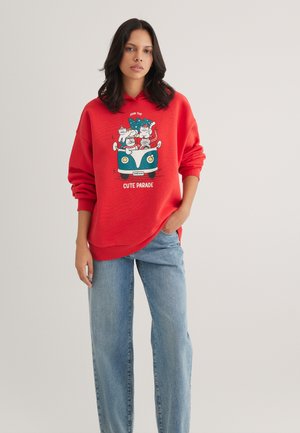 Red sweatshirt featuring a graphic of cartoon cats in a car, with the text "Cute Parade." Made from soft fabric with a relaxed fit.