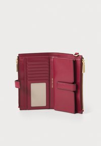 Burgundy leather wallet with multiple card slots, a clear ID pocket, and a zip-around closure. Features gold-tone hardware and stitching.