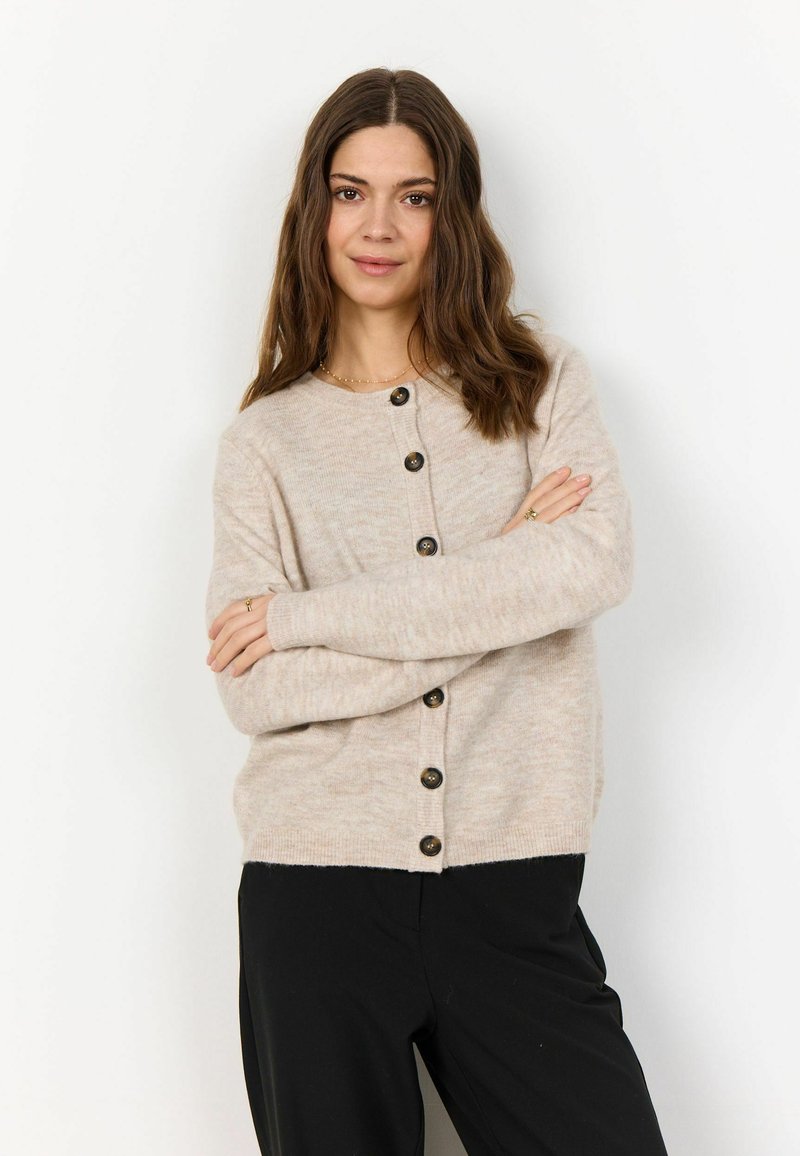 Beige knit cardigan with a round neckline, featuring dark buttons down the front and ribbed cuffs. Soft texture, relaxed fit.