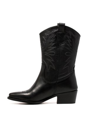 Bota de cowboy de cuero negro con punta afilada y tacón bajo apilado. Presenta patrones de costura tonales intrincados a lo largo del eje y la parte delantera.
