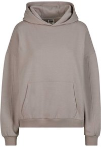 Sweat à capuche marron avec une poche avant, des poignets et une ceinture côtelés. Confectionné en tissu doux, avec une coupe décontractée et oversize.