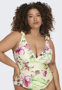 Kollane lillemustriga ühesuuline ujumistrikoo, millel on sügav V-kaelus, roosa ja roheline lillemuster ning lipsuga rihmad. Pehme materjal sileda tekstuuriga.