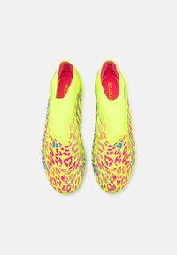 Neon yellow soccer shoes with pink leopard print. Sleek design, slip-on style, textured upper, and bold branding on sides.