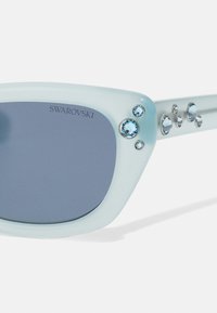 Swarovski Akiniai nuo saulės - milky light blue/polar dark blue