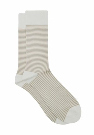 Calcetines crema con rayas horizontales en beige claro. Puños elásticos y puntera reforzada, mostrando una textura suave y un diseño sencillo.