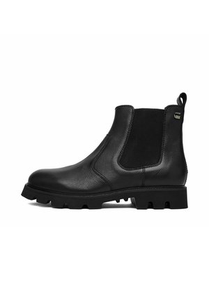 Bota Chelsea de cuero negro con panel elástico lateral, lengüeta en el talón y suela gruesa con dibujo de tracción.
