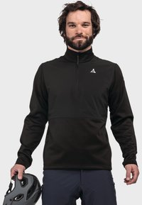 Schwarzer Fleece-Pullover mit einem Viertel-Reißverschluss-Kragen, ausgestattet mit einem kontrastierenden Brustpaneel, seitlichen Reißverschlüssen und einem Logo auf der linken Brust.