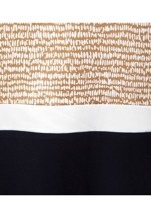 Tissu multicolore présentant un motif abstrait marron et blanc sur le dessus, avec une bande blanche et une section noire unie en bas.