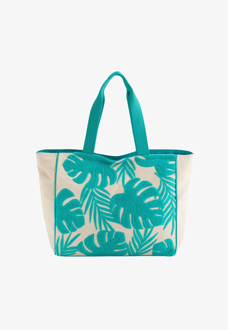 Tote bag made of natural canvas with turquoise leaf patterns and textured accents. Features matching handles and contrasting edging.