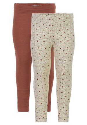 Zwei Leggings: eine in rostfarbenem Baumwollstoff, die andere in Creme mit floralem und gepunktetem Muster. Beide haben elastische Taillenbündchen.