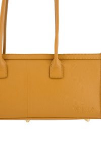 Mustard yellow leather tote bag with a textured finish, two handles, and subtle branding. Features a rectangular shape and stitched edges.