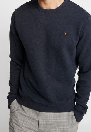 Sweatshirt bleu marine à col ras du cou en mélange de coton, avec des poignets en rib et un ourlet en rib, doté d'un petit logo doré brodé sur la poitrine.