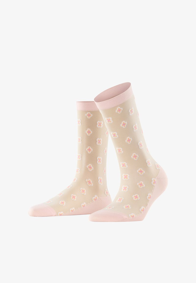 Chaussettes beige clair avec poignets, talons et orteils roses, présentant un motif répétitif de petites fleurs roses et blanches.