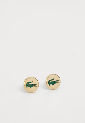 Gold-tone stud earrings featuring a green crocodile logo with red accents, smooth surface, and circular design.