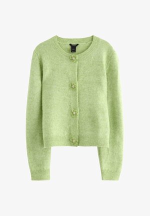 Cardigan verde realizzato in morbido tessuto a maglia. Presenta una scollatura tonda, maniche lunghe e bottoni floreali per la chiusura. Design corto.