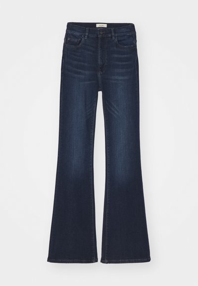 Dark blue flared jeans with a mid-rise waist, featuring front pockets and a smooth denim texture. A classic design with minimal stitching.