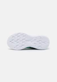 White athletic shoe sole with a textured surface, featuring a green and black patterned upper and a lightweight design for flexibility.