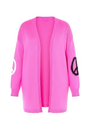 Vaaleanpunainen pitkähiha cardigan neuloksesta. Avoin edestä, yhdellä hihalla valkoinen rauhankuvio ja toisella musta.