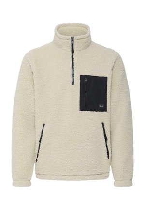 Sudadera de forro polar color crema con cierre de cuarto y bolsillo en el pecho con cremallera negra, además de bolsillos laterales.