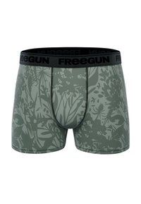 Boxer-chaussettes vertes avec un motif floral, en tissu extensible. Équipés d'une ceinture noire avec le logo "FREEGUN" et d'un ajustement serré.