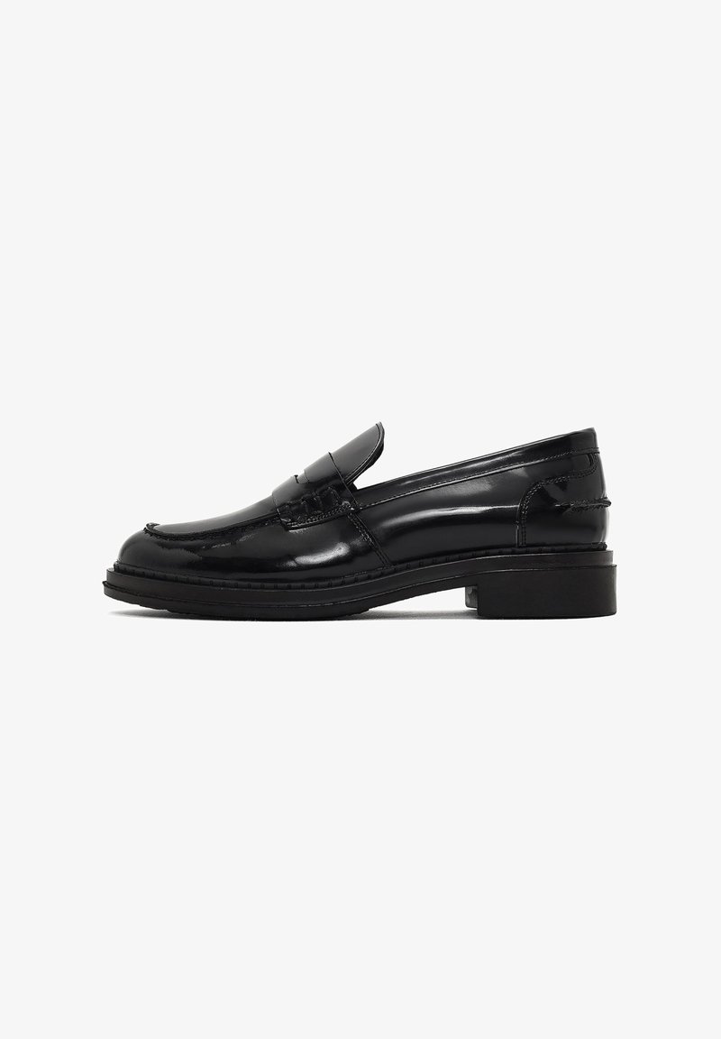 Black patent leather loafers with a rounded toe, decorative upper strap, low-block rubber heel, and visible stitching detail.