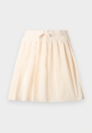 Jupe plissée couleur crème avec taille élastique et cordon de serrage, arborant un logo Nike discret près de l'ourlet.