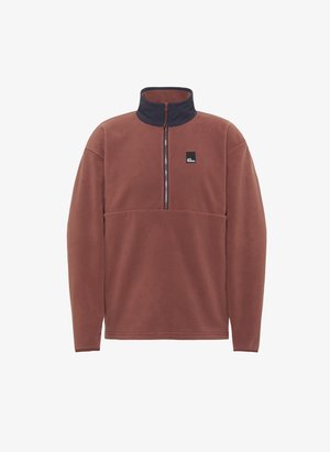 Bruine fleece pullover met een hoge kraag en een rits aan de voorkant. Marineblauwe kraagrand en borstplooi. Beschikt over een klein zwart logopatch.