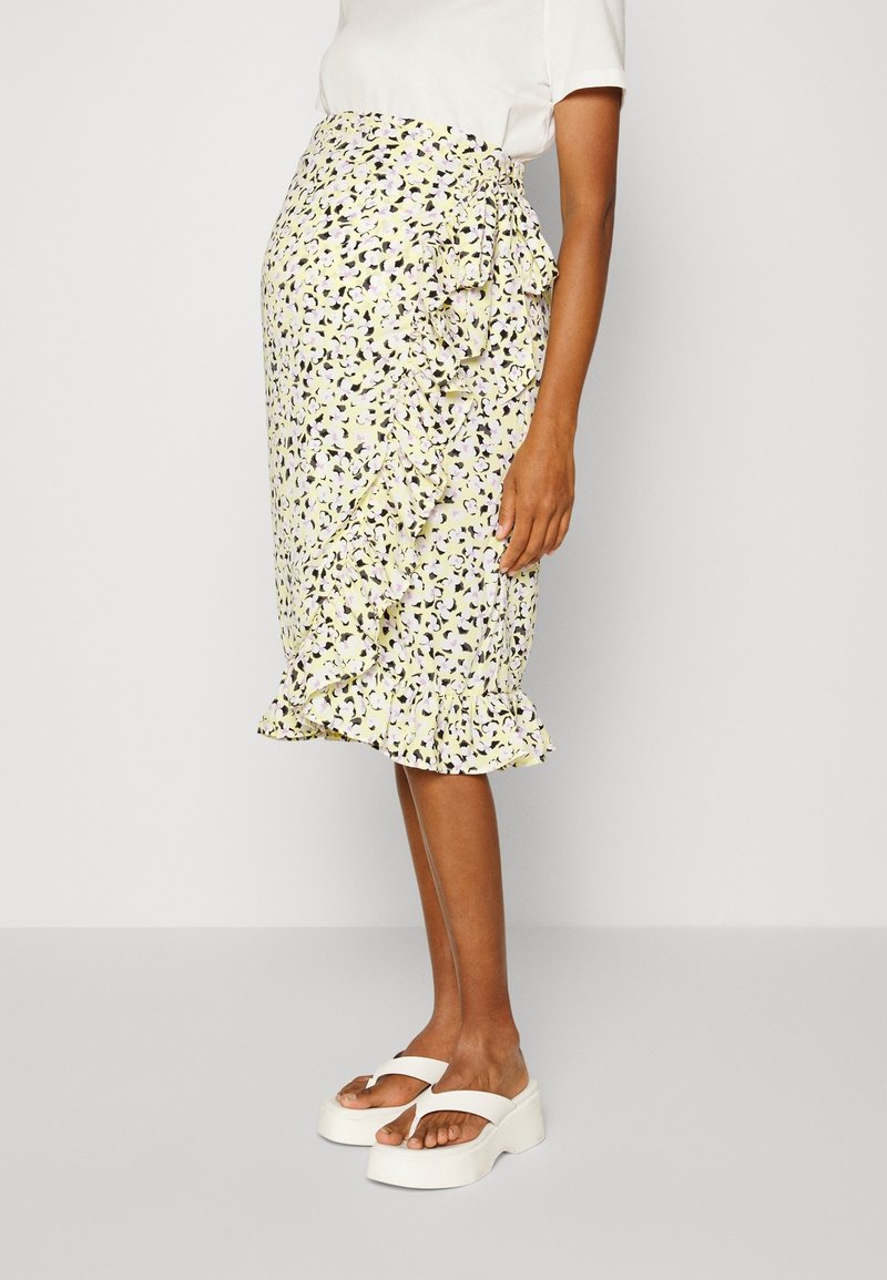 Geel bloemenprint midi-rokje met ruches, uitgevoerd in een bodycon pasvorm en een uitlopende zoom, gecombineerd met witte platformsandalen.