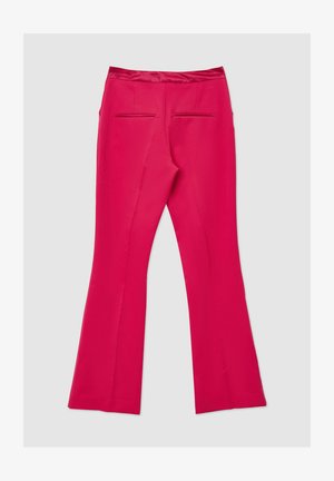 Flared pink trousers with a smooth texture, featuring a satin waistband and two back pockets. The design is fitted through the hips.