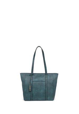 Sac cabas bleu sarcelle foncé avec fines bretelles, poche avant et petite étiquette rectangulaire sur une sangle, présenté sur un fond blanc.