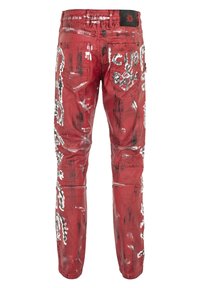 Rote Jeans mit künstlerischen schwarz-weißen Farbspritzern, im taillierten Design, mit mehreren Taschen und einem Markenlabel am Bund.