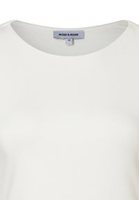 White round neck t-shirt made of soft fabric with a smooth texture. Features a tag with "MORE & MORE" brand and size 36.