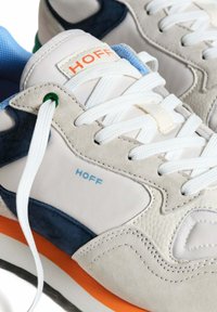 Baskets blanches avec des accents en daim bleu marine et orange. Comprend une languette en mesh et des lacets ; logo "HOFF" affiché en bleu.