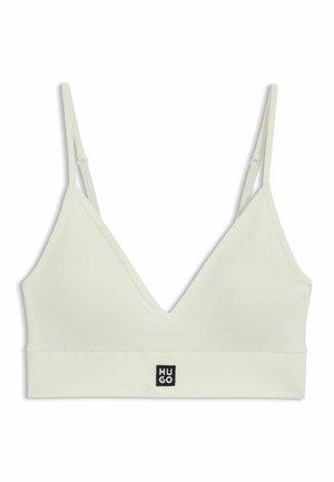 Light yellow bralette with ribbed texture, V-neckline, adjustable straps, and a solid band featuring a black logo tag at the front.