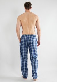Blauwe en witte geruite pyjamabroek met een elastische tailleband en een recht jeansontwerp, met een soepele stoftextuur.