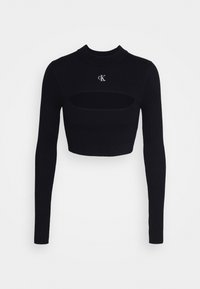 Schwarzes, gestreiftes Langarm-Crop-Top mit hohem Kragen und Ausschnittdetails an der Brust, mit kleinem weißem "cK"-Logo auf der Vorderseite.
