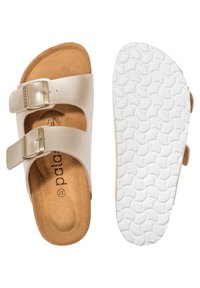 Light beige sandals with two adjustable straps, metallic buckles, and a cork footbed. The sole is white, textured with a wave pattern.