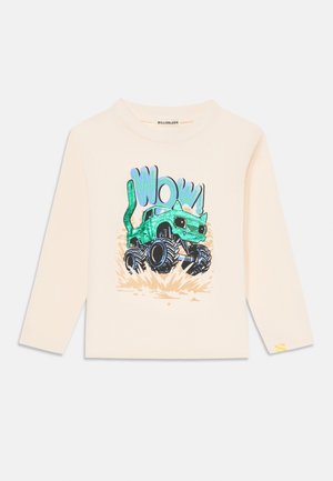 Long-sleeve cream T-shirt featuring a colorful graphic of a monster truck with green accents and playful "WOW!" text. Soft cotton material.