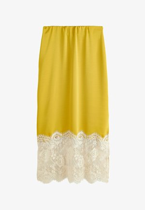 Gelber Rock mit elastischem Bund und breiter weißer Spitzenborte mit Blumenmuster am Saum.