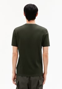 Dark green cotton t-shirt with short sleeves, round neckline, and a smooth texture. Back view shows a simple design with minimal detailing.