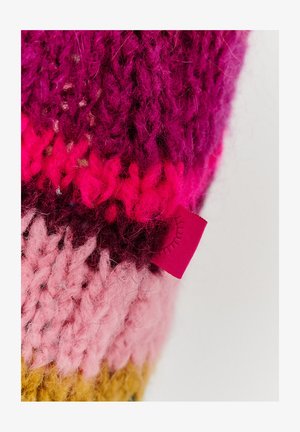 Pletený vlnený doplnok s viacerými odtieňmi ružovej, fialovej a žltej. Obsahuje malú červenú nálepku na boku so slnečnými lúčmi.